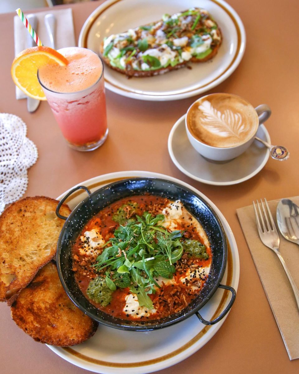 top down shot of baked eggs with a coffee and juice.