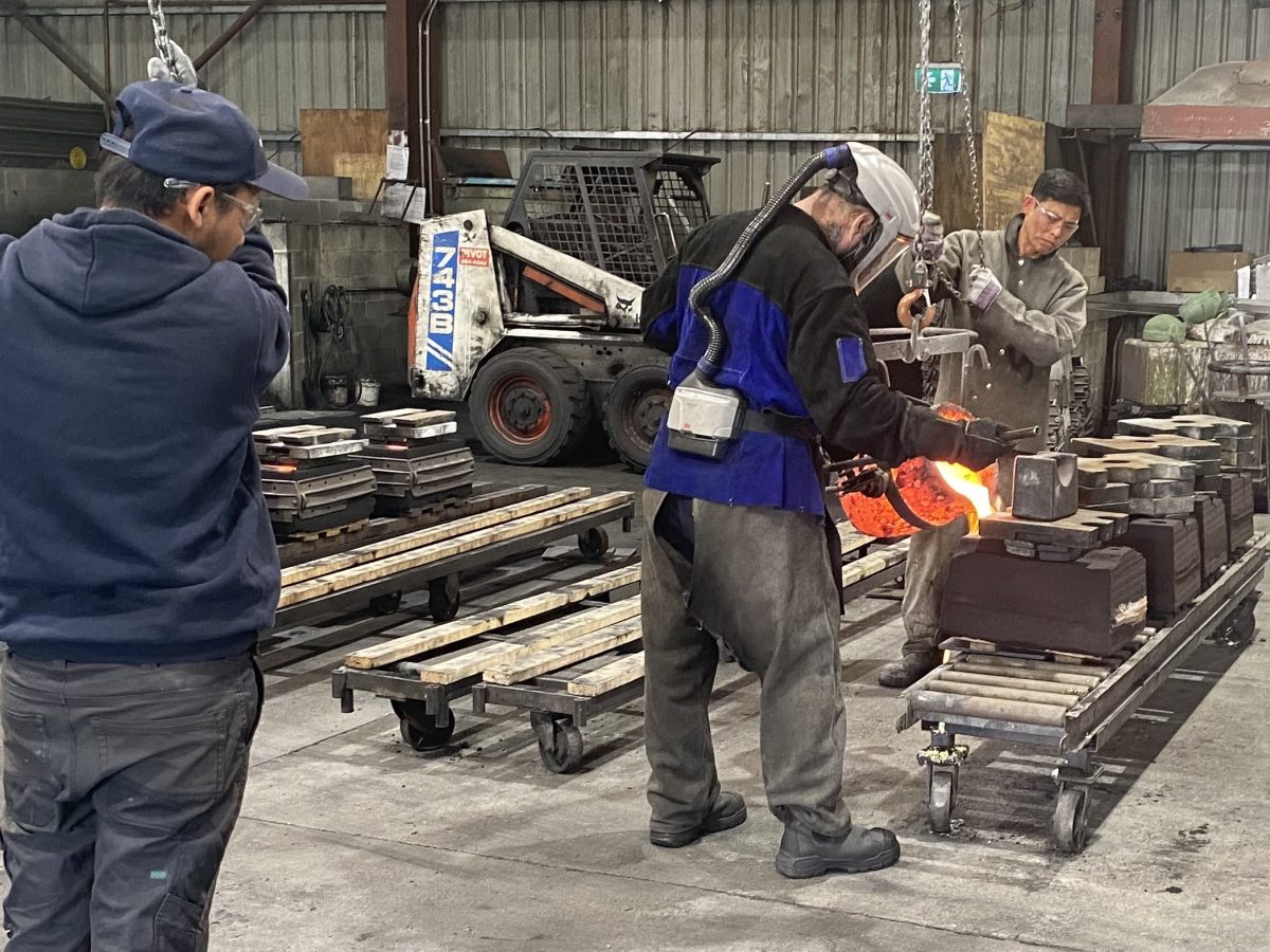 Pouring silicon bronze heated to 1150 degrees Celsius into moulds for designer lights at Camcast Foundry, Goulburn.