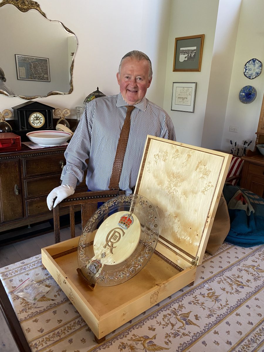 Man with royal glass plate in a box