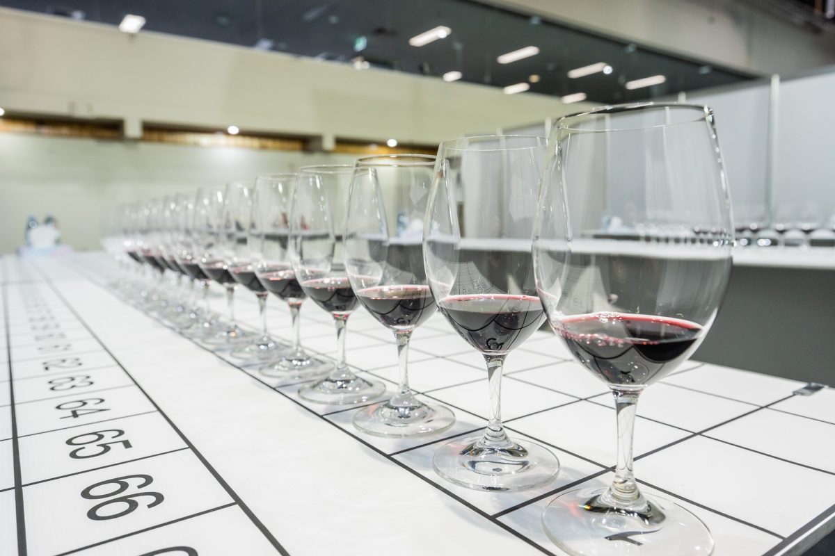 row of glasses of red wine submitted for judging