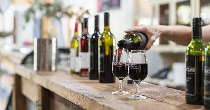 Premium wine tasting event photo with bottles on bench