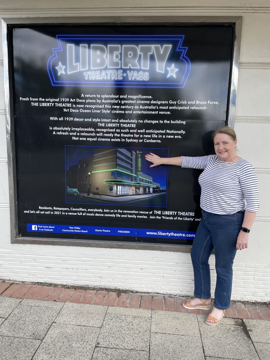 Woman standing in front of big sign