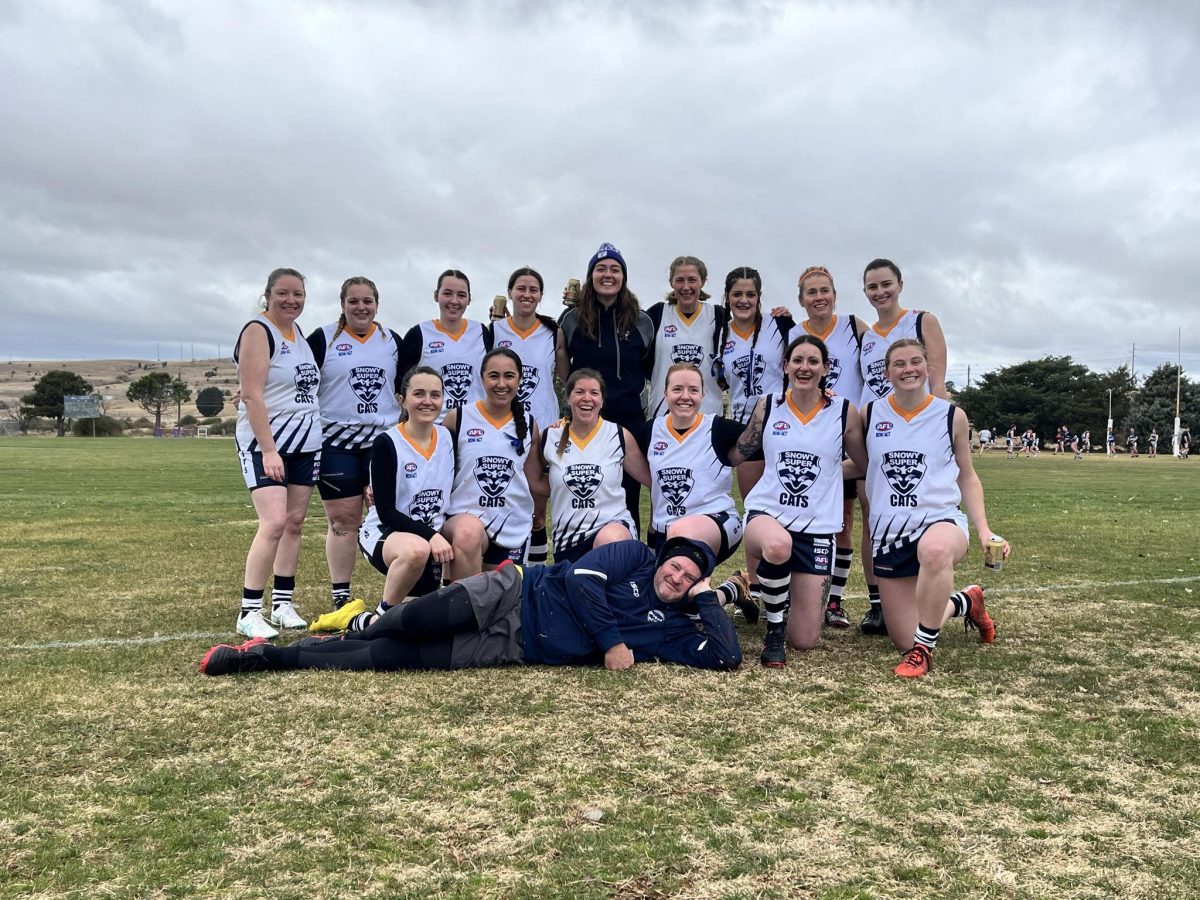 Women in matching sports jerseys standing in a group