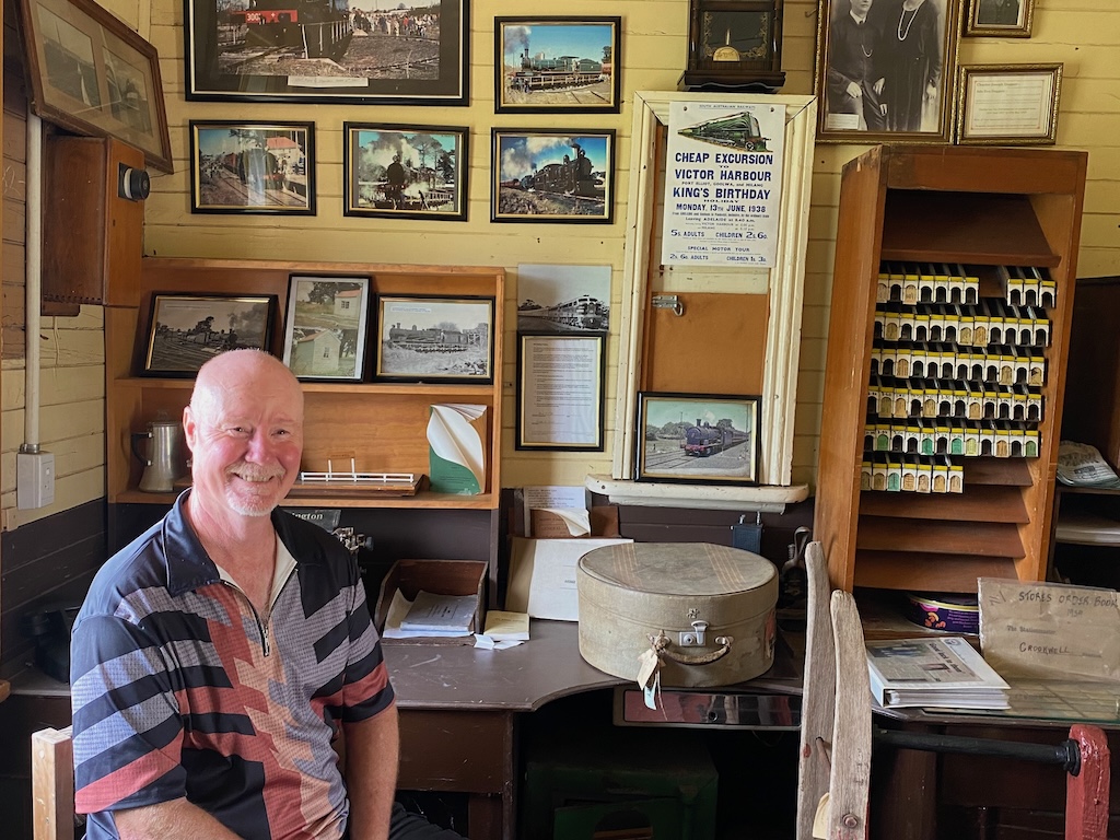 A wooden luggage trolley, office chair, desk, typewriter and sign-on book, with the last date of 28 June, 1989, sit exactly where they were left inside Crookwell Railway Station. Sitting in the heritage-listed station, Mick Bindley says interest in heritage rail has never been stronger.