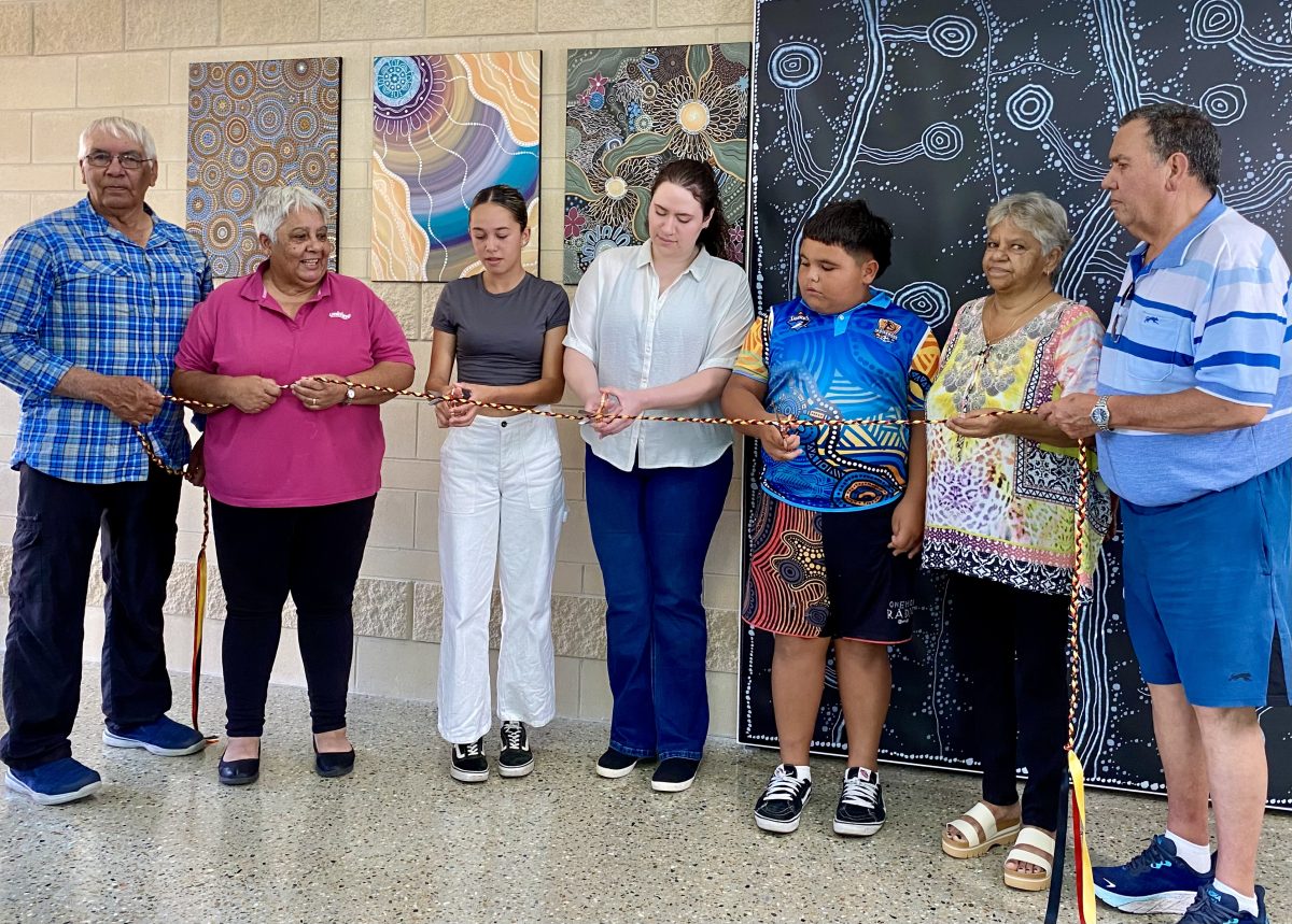 A group of people at a building's ribbon-cutting ceremony