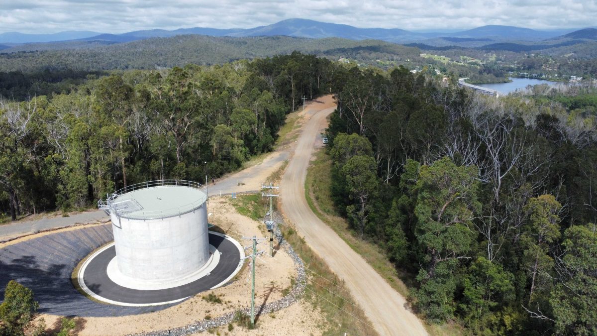 Aerial view of a concrete cylinder next to bushland.