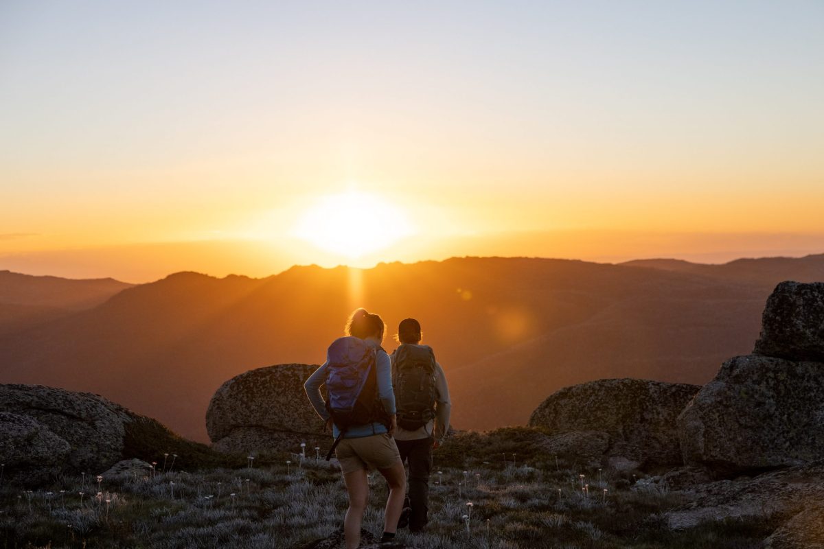 two people walking at sunset