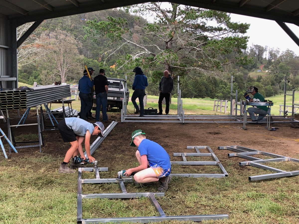 Volunteers preparing the showground for the Cobargo Show bring along their children which gets them involved from a young age.