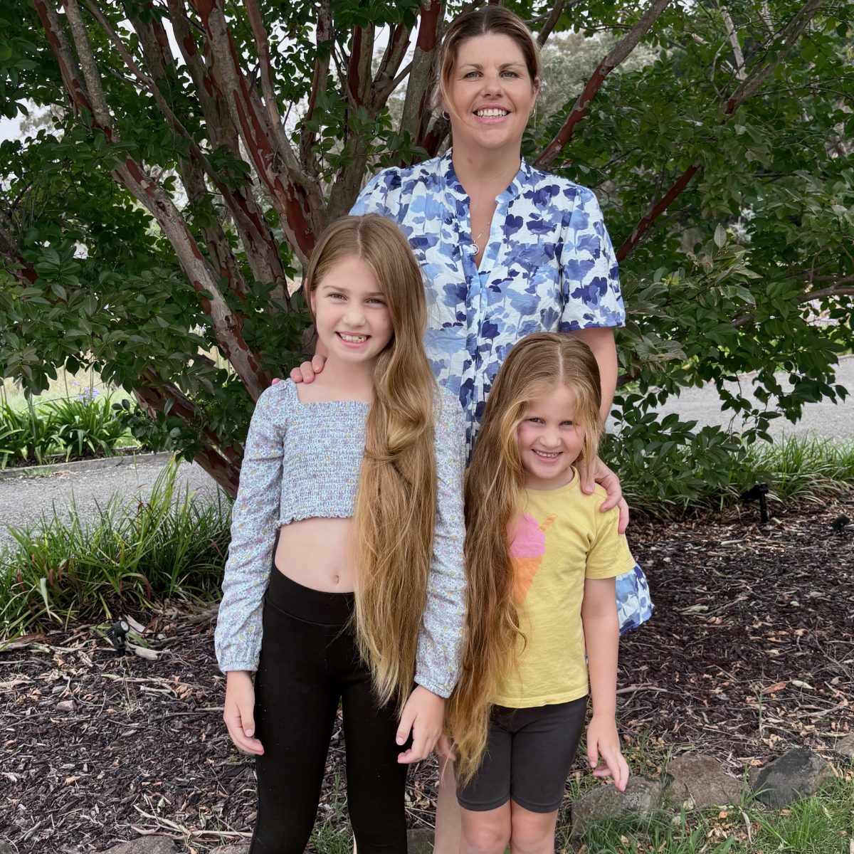 Loretta Jones with her thoughtful daughters Annabelle, 8 and Zaylee, 5, having a family photo ahead of their final week of fundraising. The girls’ extraordinarily long locks of gorgeous hair will be carefully prepared for donating to Wigs4Kids and children less fortunate than themselves. 