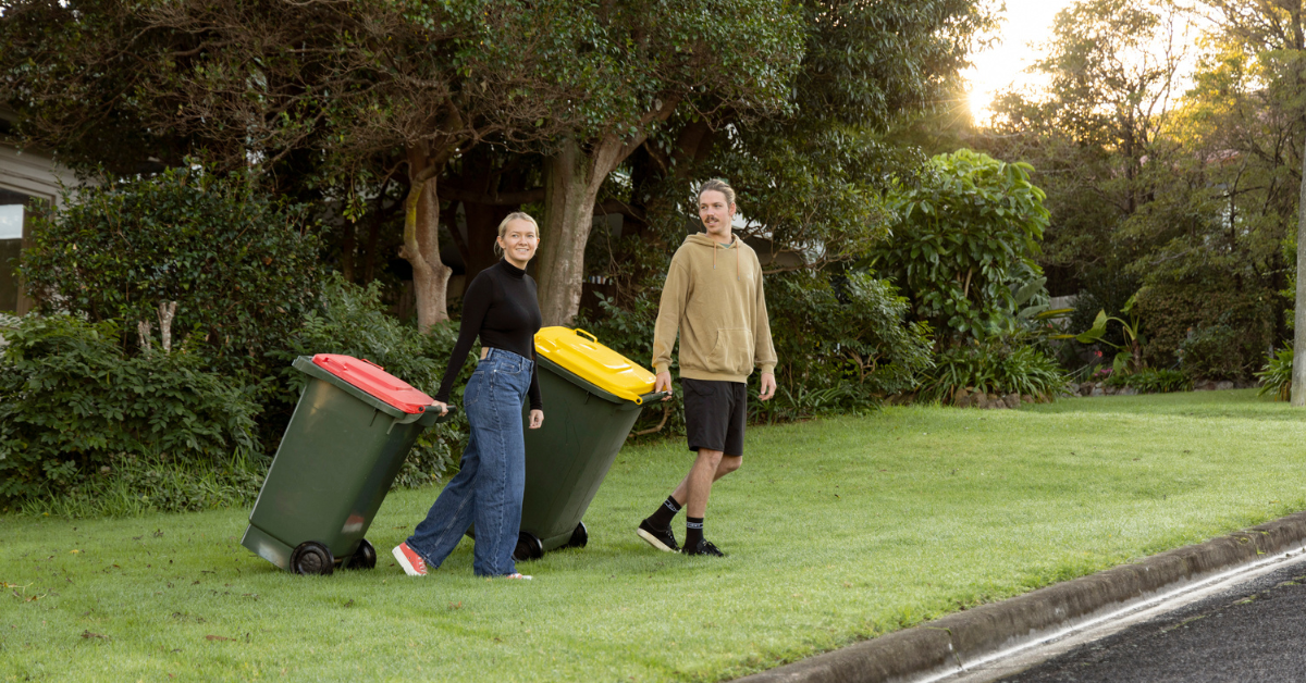 People wheeling bins out