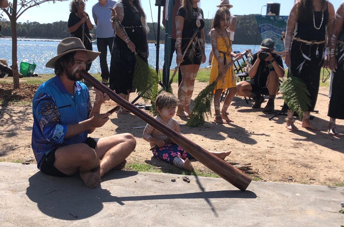 Brock Tutt playing the didgeridoo and his son Binnin-gala Tutt playing the clapsticks during the smoking ceremony.