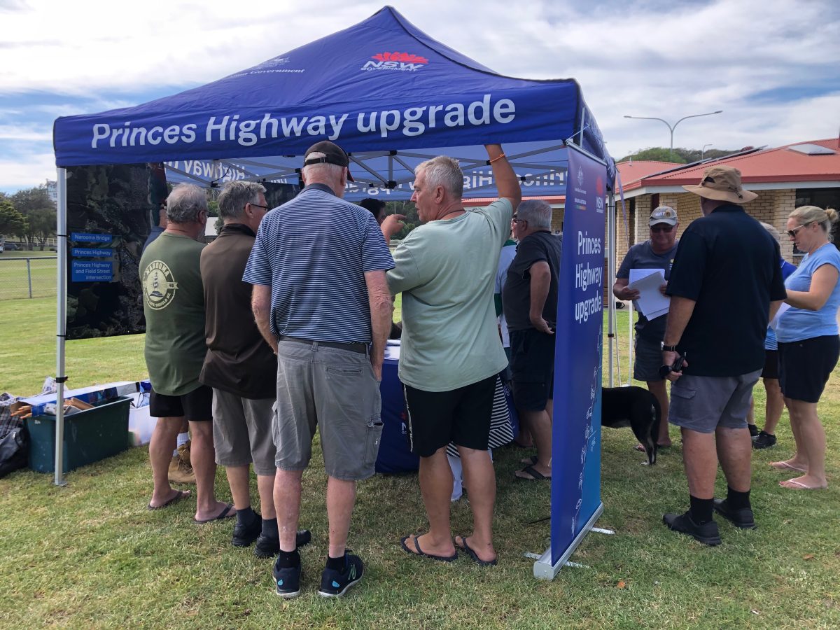 people at an information tent