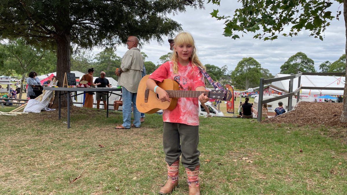 A young busker at the Cobargo Folk Festival in 2024. 