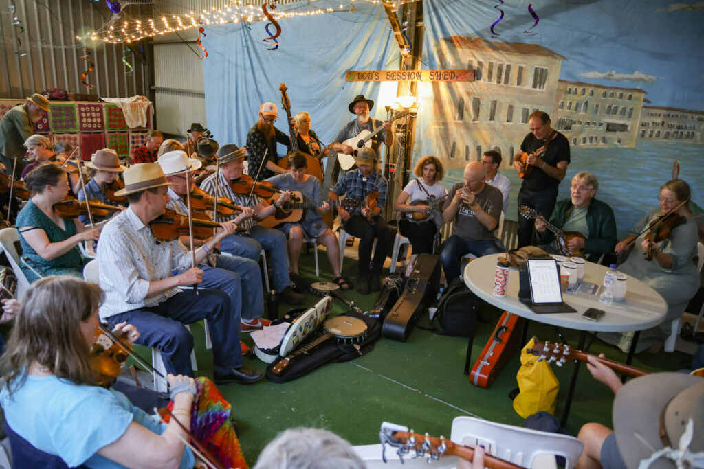 a photo of musicians playing in a shed