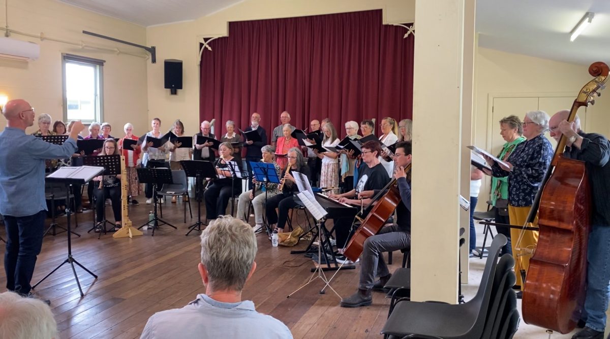 A choir and musicians performing in a hall