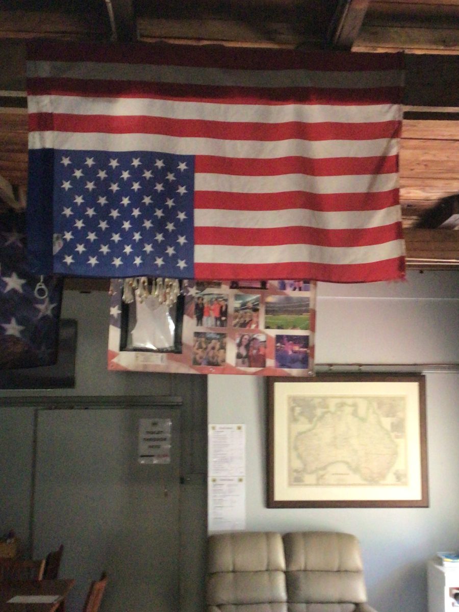 An American flag hanging upside down in a cafe