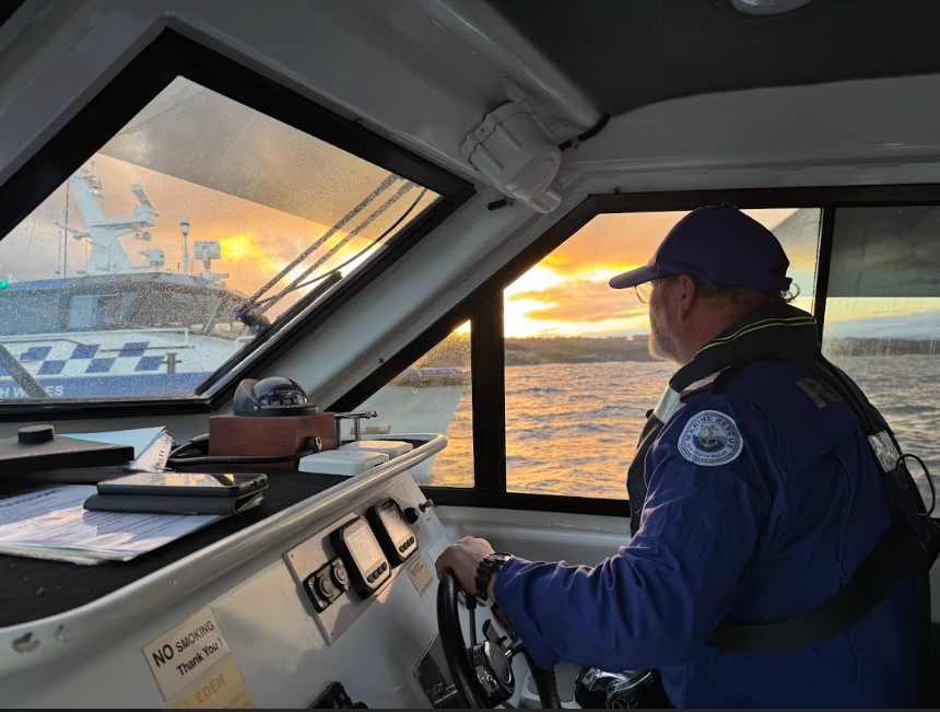 A Marine Rescue volunteer looking out at another boat