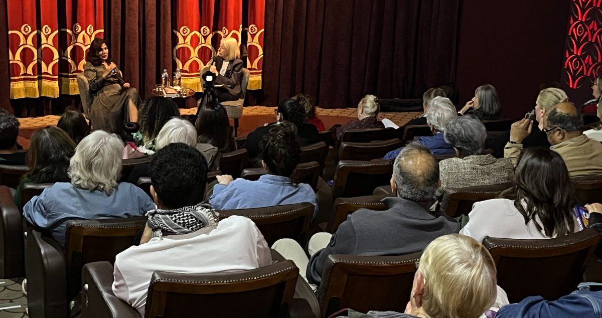 two women hosting a book talk in front of an audience in a theatre