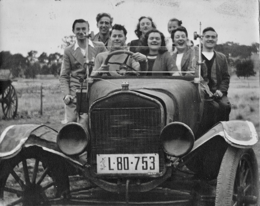 old photo of people in a car