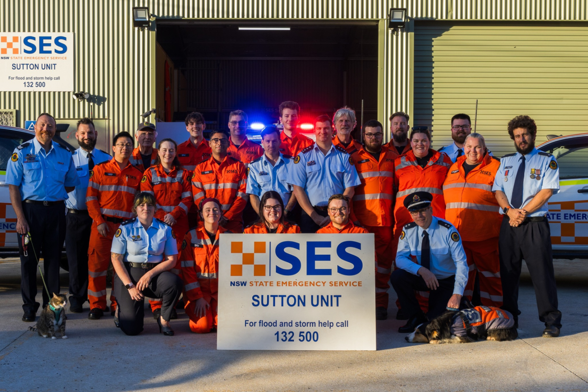 A large group of uniformed volunteers in front of the unit premises