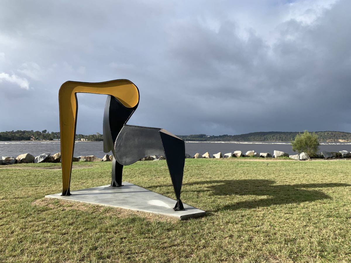 The sculpture with water in the background