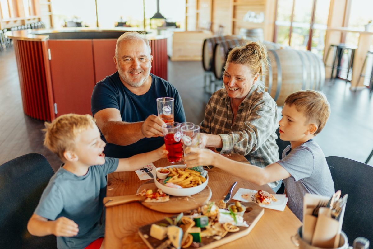 family toasting at lunch in a restaurant