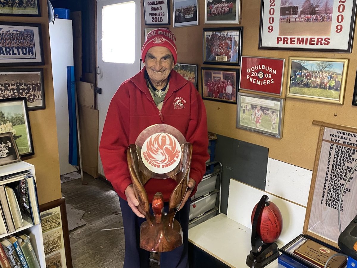 Goulburn Swans historian and life member Bob Stephens with the club’s emblem, carved from a tree stump by his grandson James Doyle. He plans to put all the names of life members onto the polished ornament.