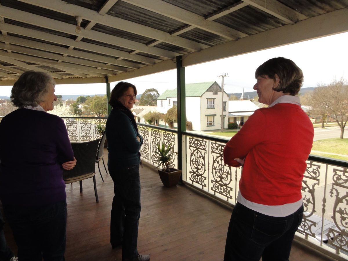 Jepsen sisters Susie, Kate and Margie on the balcony of the former corner store in Goulburn several years ago, reminiscing about the days of the landmark business.
