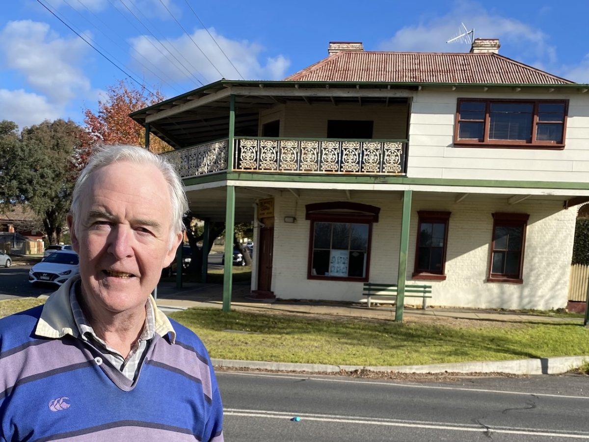 Greg Jepsen outside the former family corner store on the corner of Cowper and Clifford Streets, Goulburn. The family slept in three bedrooms upstairs including the boys' bedroom on the open balcony with a large blind (now enclosed, at right). Susie remembers the boys hanging their socks through chicken wire to air at night. One freezing winter’s morning they discovered the socks were frozen stiff.