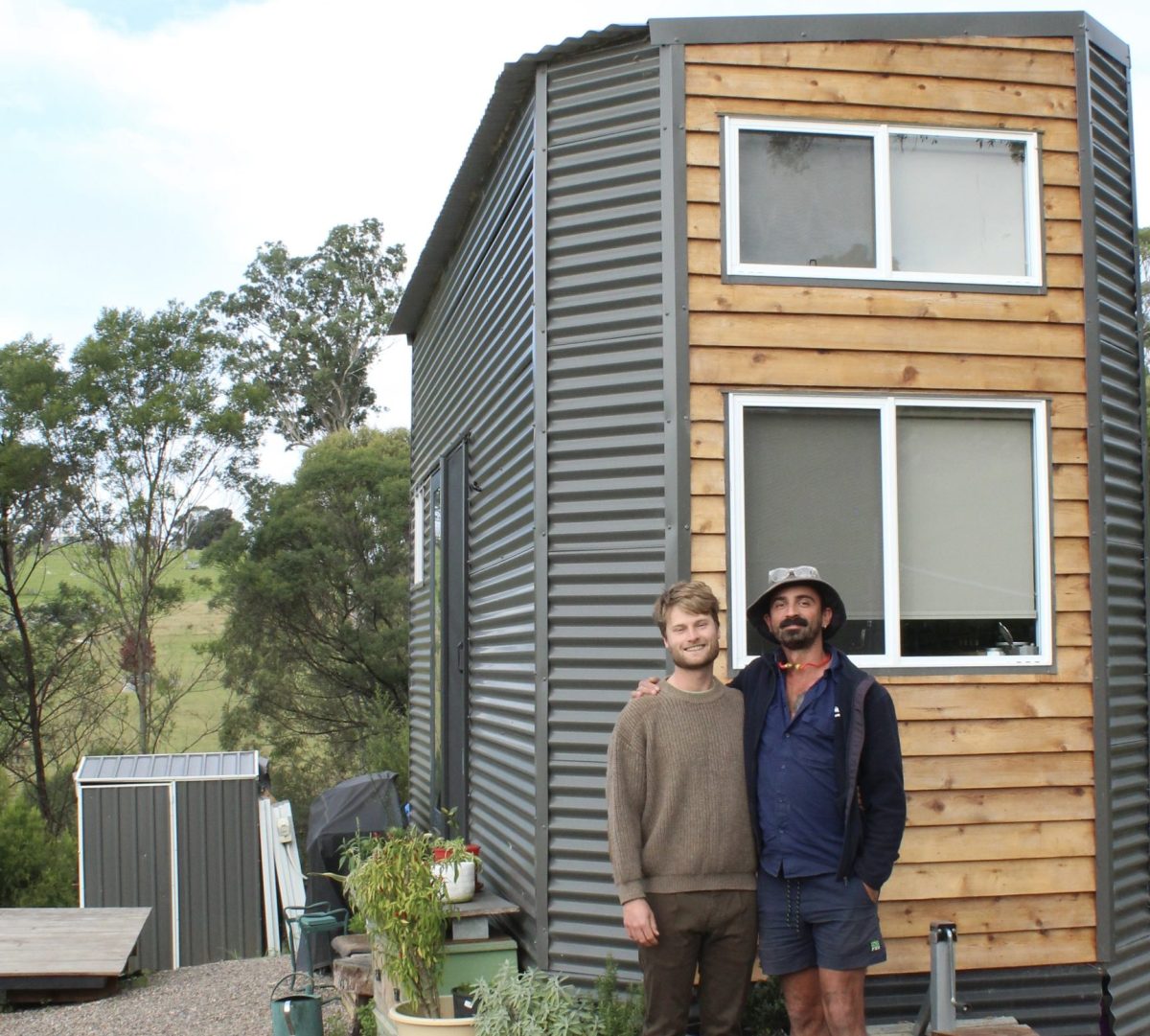 Josh Heins and Manu Bohn outside their tiny home.