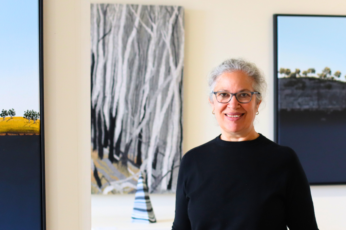 Woman stands in art gallery.