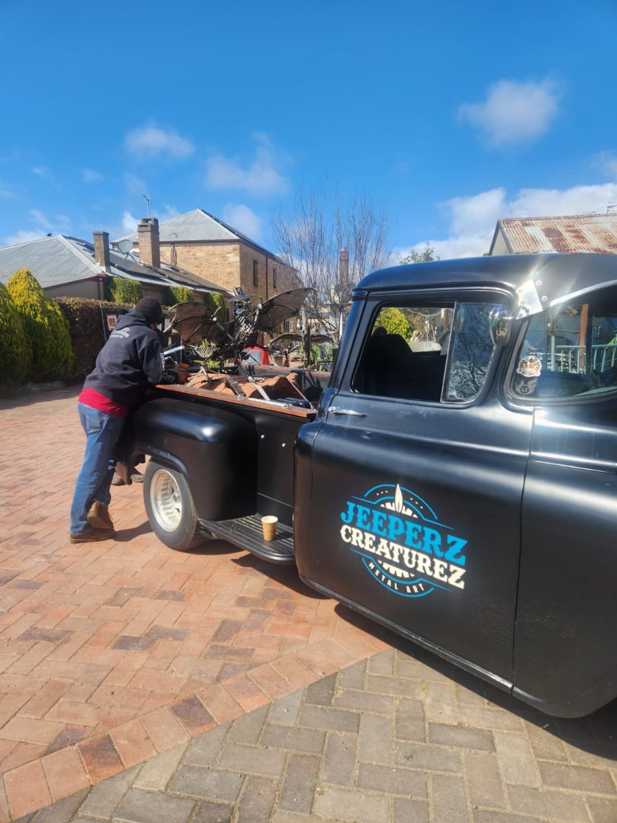 man unloading sculptures from truck