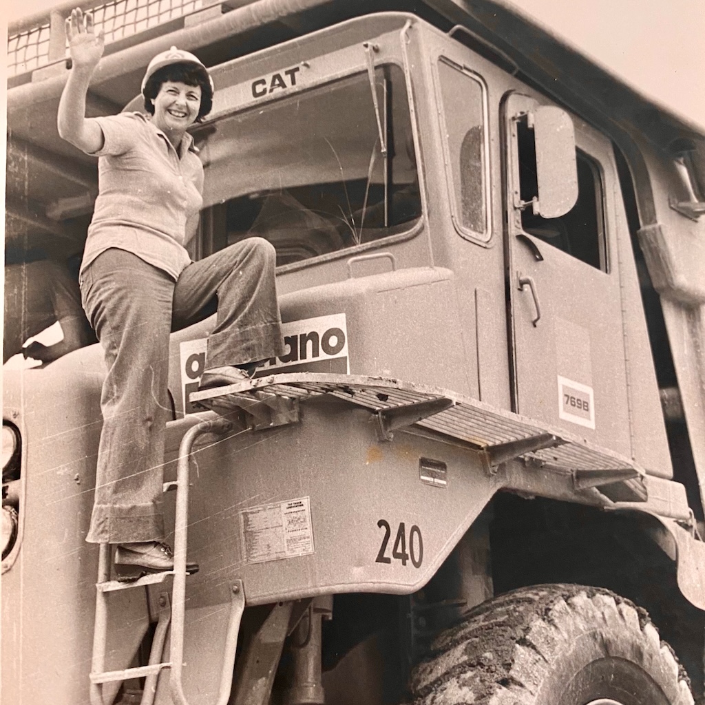 Barbara Todkill climbs up one of Woodlawn Mine’s first Caterpillar D-9 dozers. Women were employed to drive the monster vehicles, an innovation of mine principal, Mike Blackwell, a South African ahead of his time.
