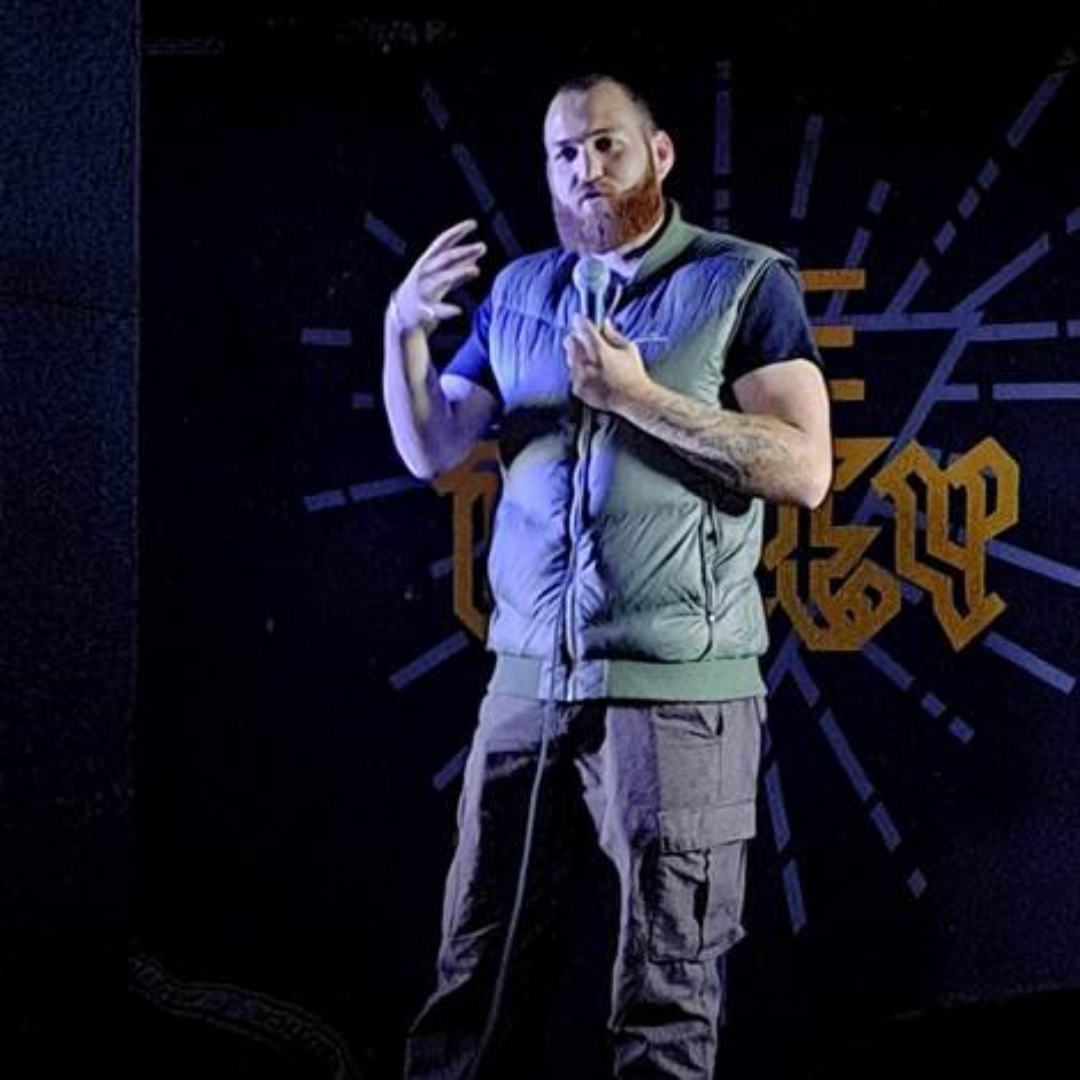 Man on stage with microphone.