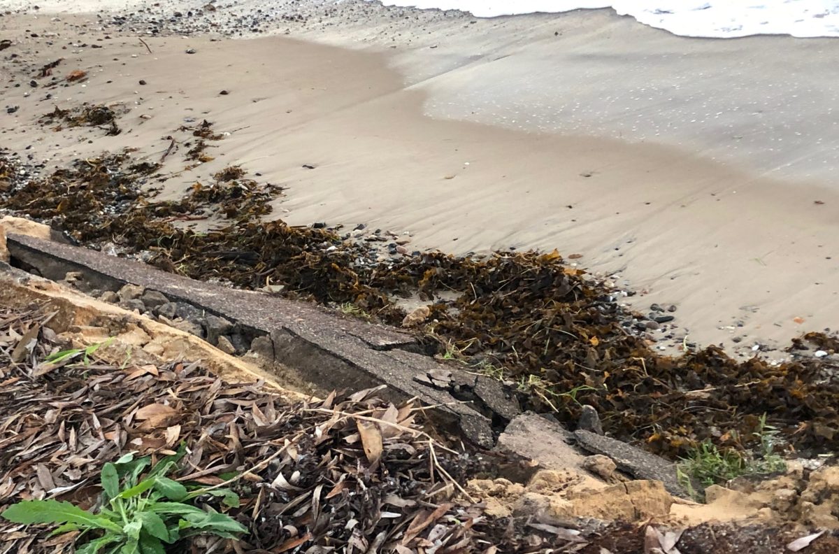 A section of the asphalt track near Long Swamp in Bermagui that has collapsed and fallen down onto the beach.
