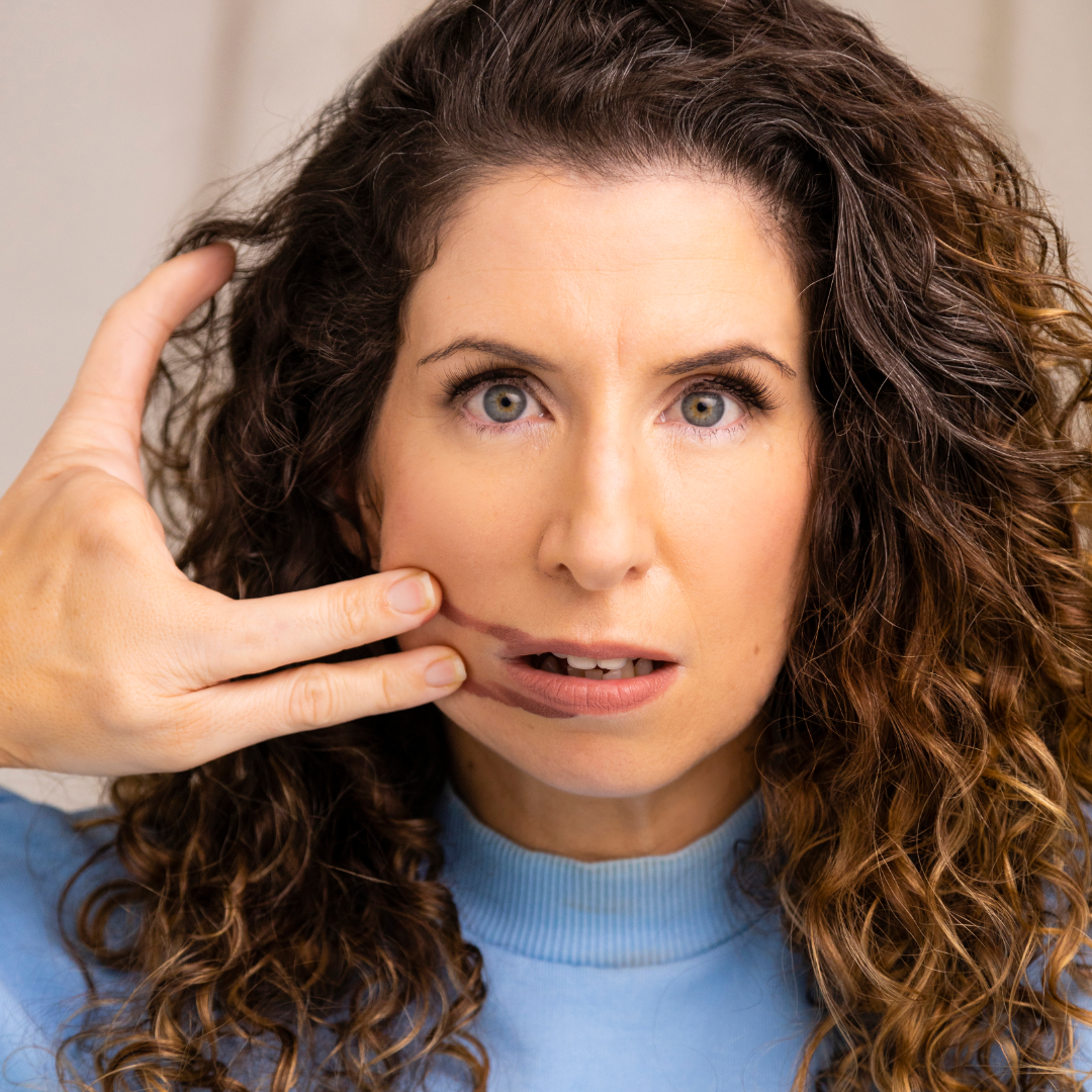 Woman with hand on her face.
