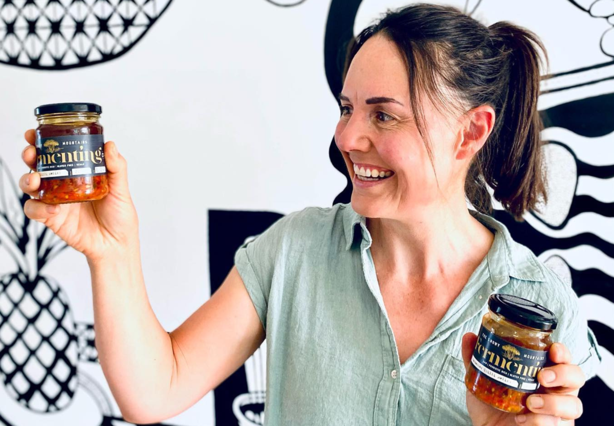 Woman holding jars of kimchi