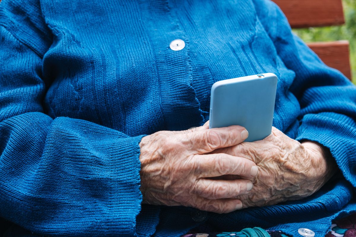 elderly woman holding a mobile phone
