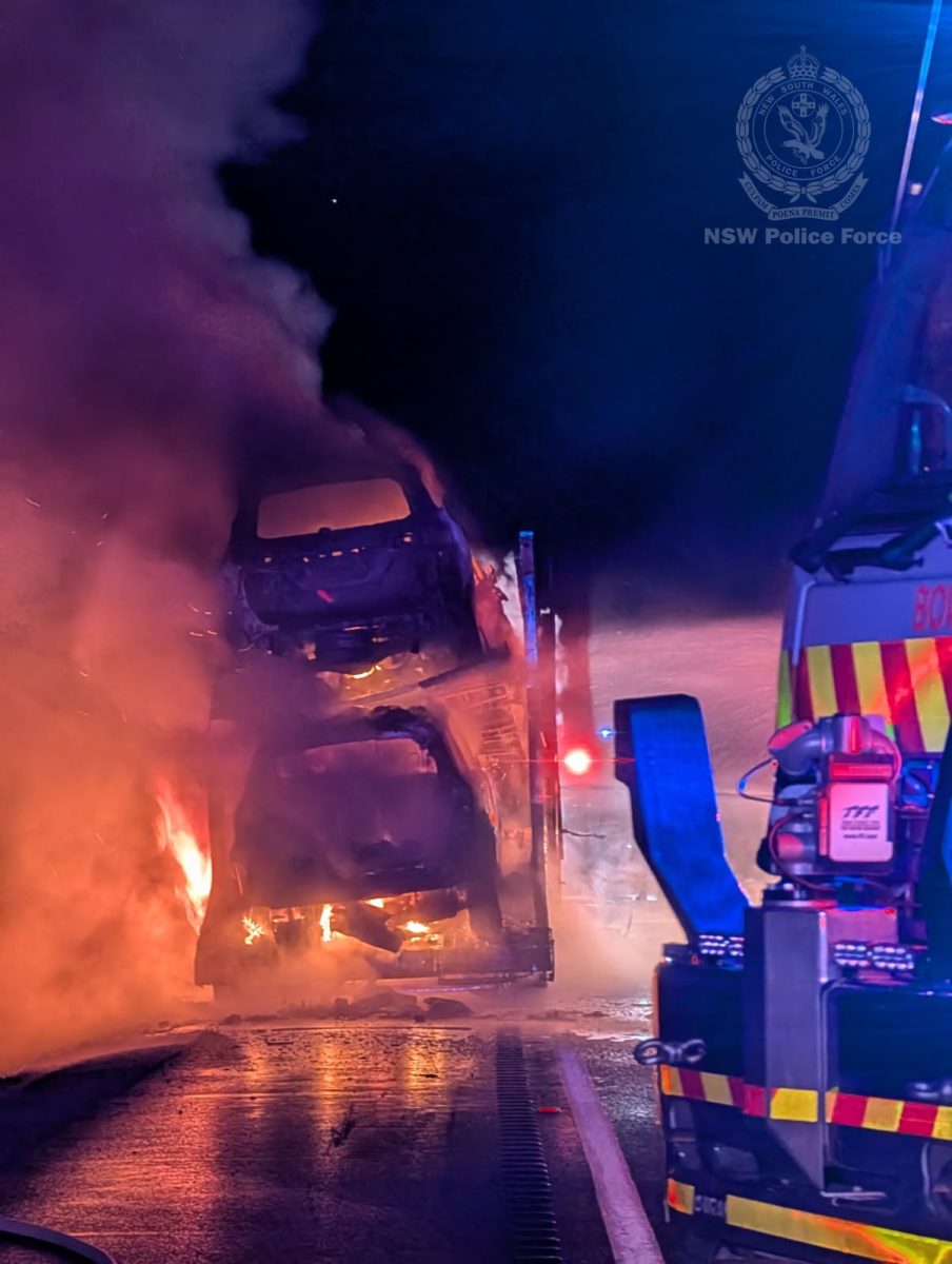 Burning cars on a transport vehicle