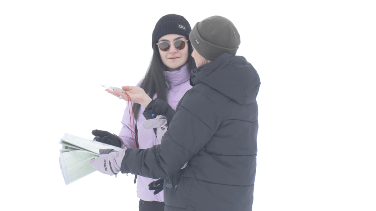 A woman holding a map and talking to another woman