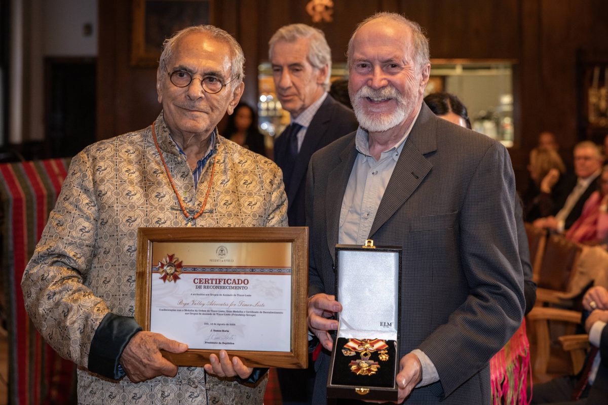 two men with awards and medals