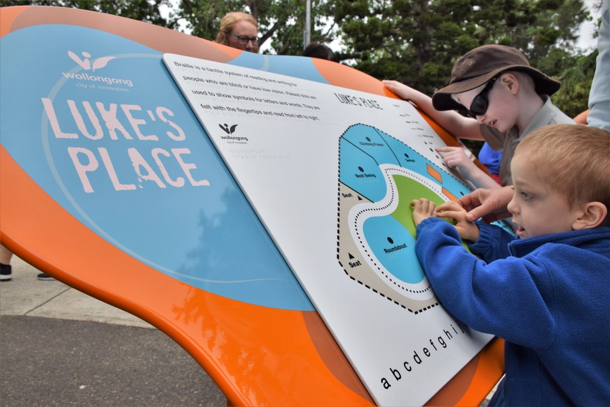 Kids reading a braille map at a Wollongong park