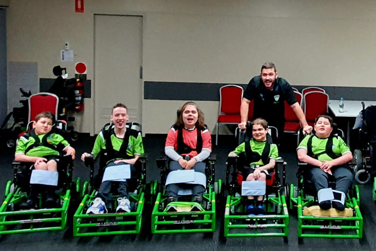 man with kids in powerchairs