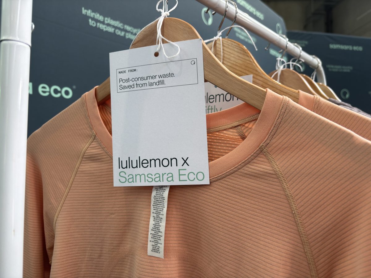 A photo of a pink jumper on a hanger, made from recycled plastics