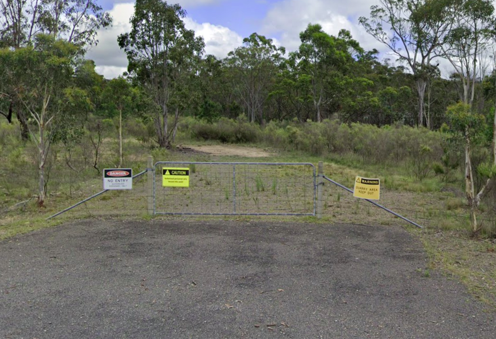 A gate at the end of a road leading to bushland