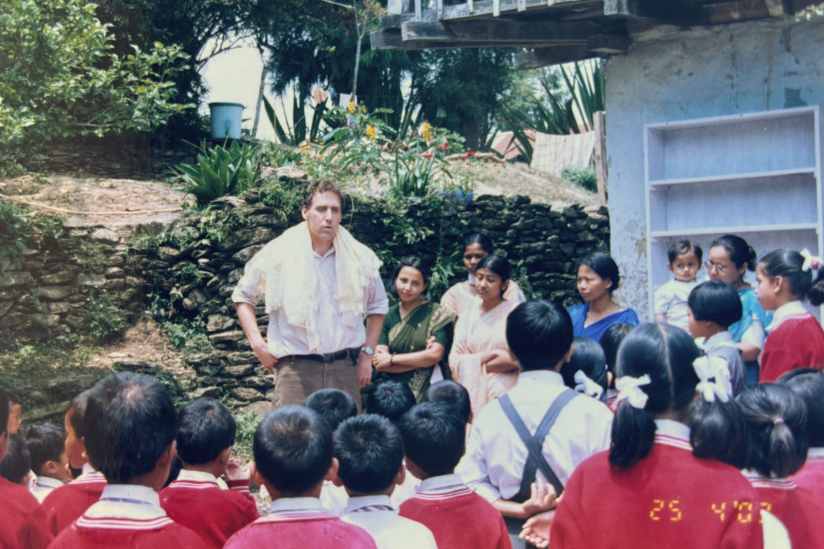 Man standing in front of group of students in India.