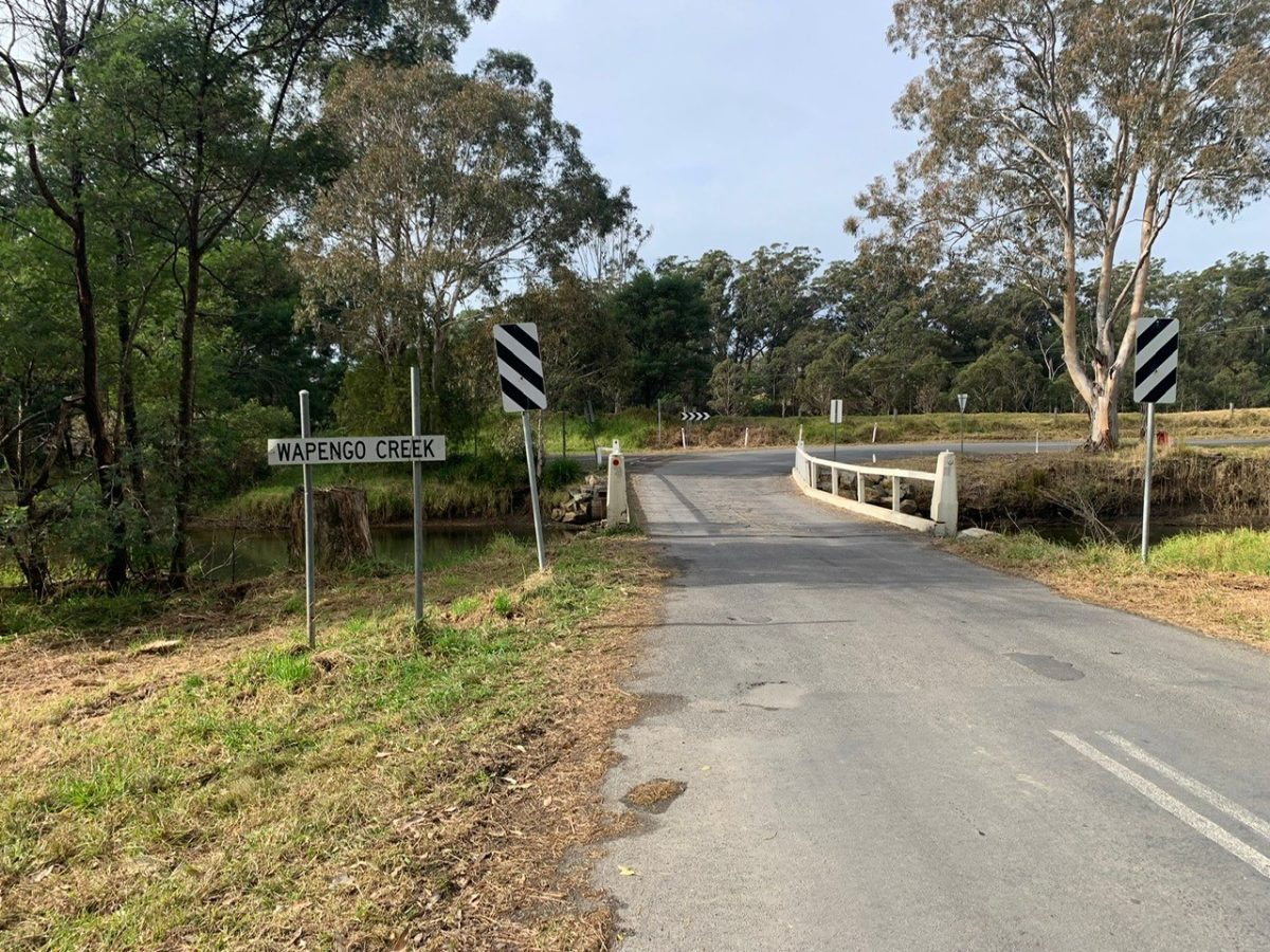 A sign for a creek in a rural area