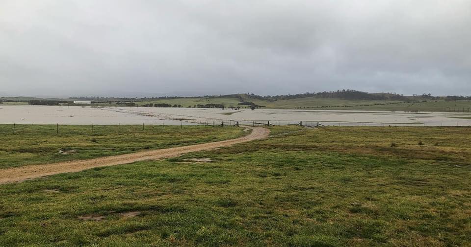 A river flooding fields on a rainy day