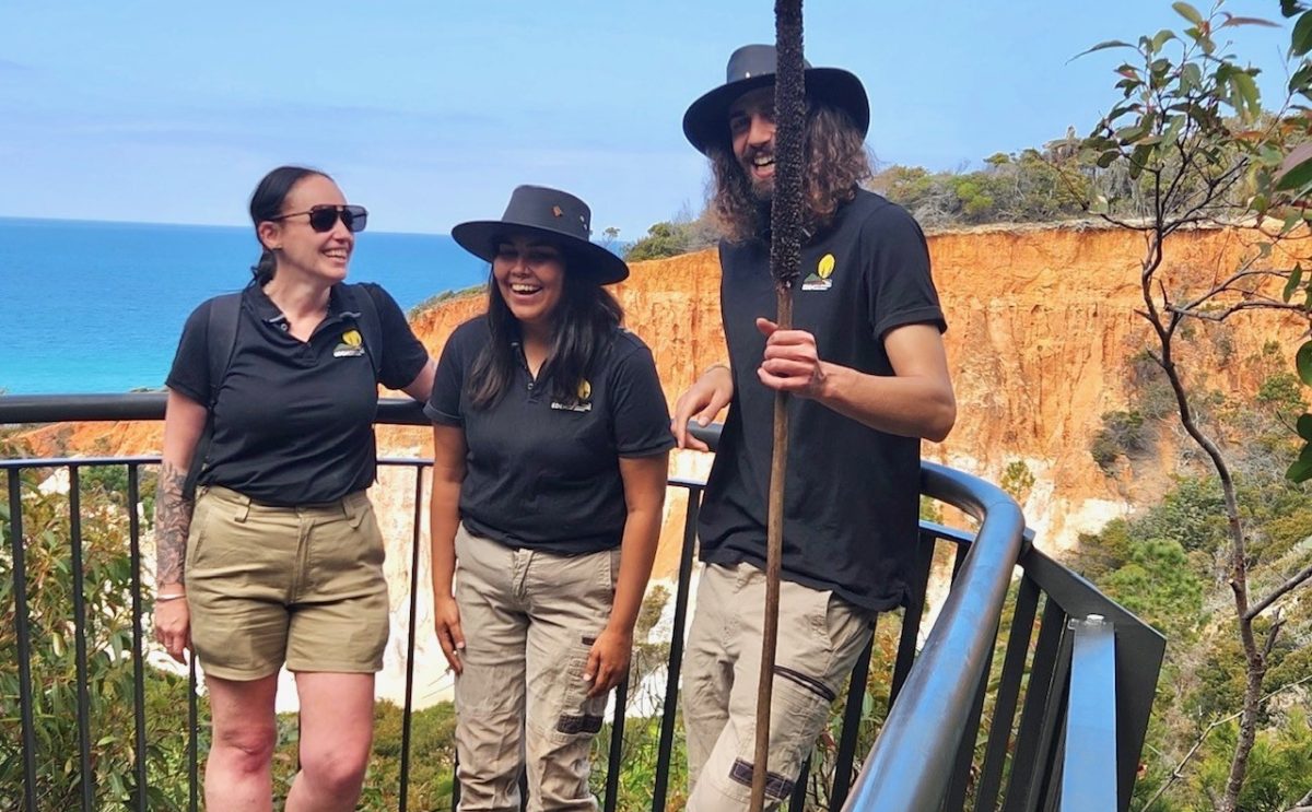 three people at a hillside lookout