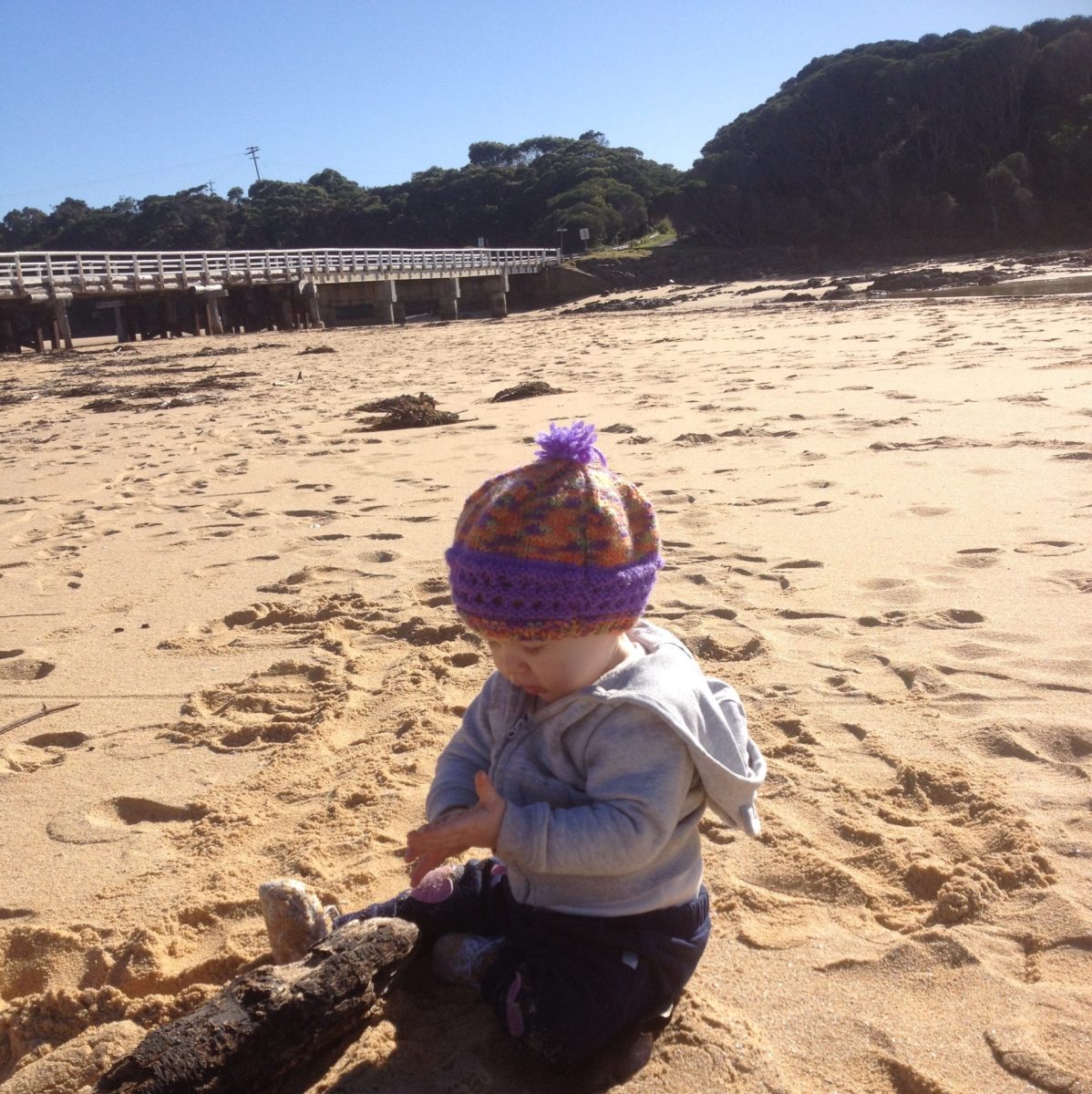 toddler playing at a beach
